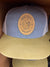 Buc-ees Adult Blue, Beige and White Ball Cap with Brown Leather Logo on Front and Adjustable Strap